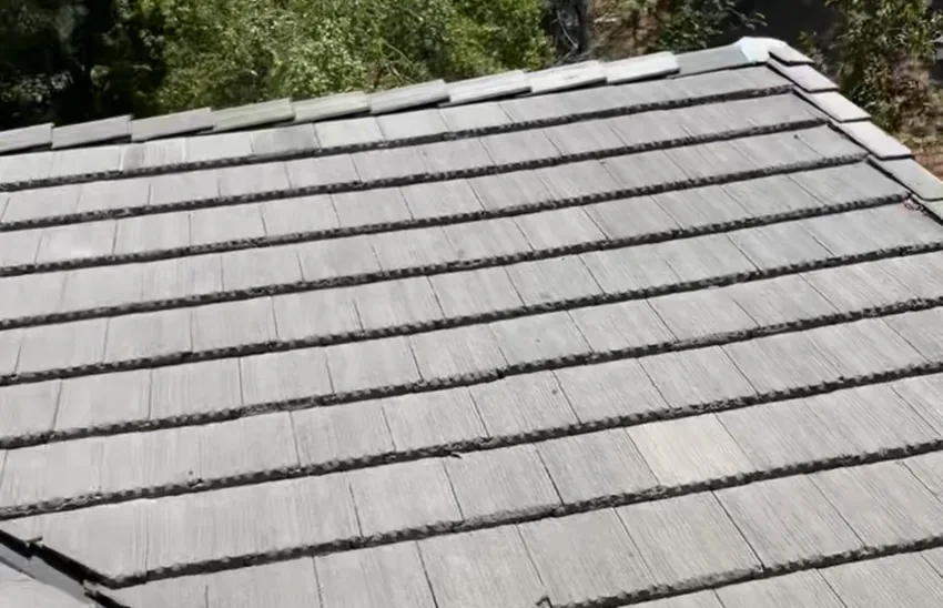 Close view of gray flat tiles laid in overlapping rows on a sloped roof